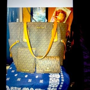 Michael kora purse and 2 matching wallet’s nwot purse is 300 and wallets are 75